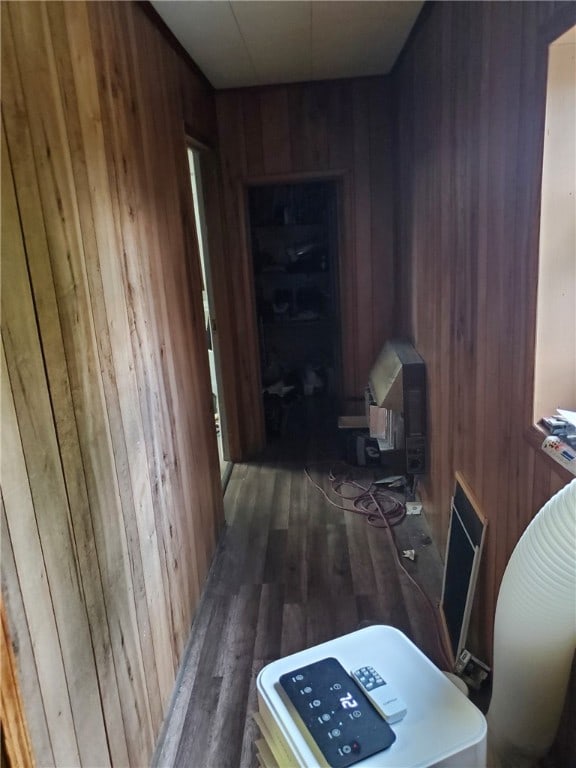 hall featuring dark hardwood / wood-style flooring and wood walls