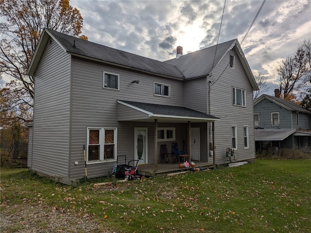 back of property featuring a yard and a patio area