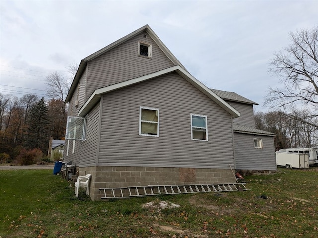 view of property exterior featuring a lawn