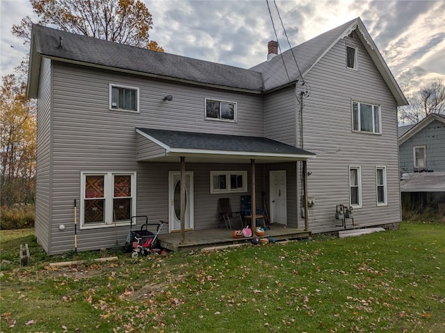 rear view of house featuring a patio and a yard