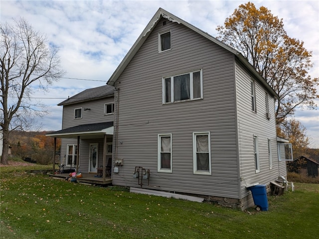 rear view of property with a lawn