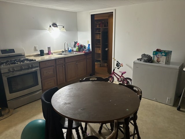 kitchen featuring stainless steel gas range and sink