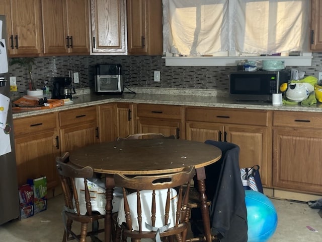 kitchen featuring light stone counters and tasteful backsplash