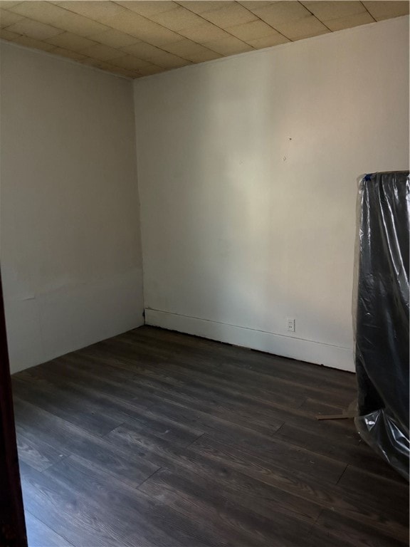 unfurnished room with dark hardwood / wood-style floors