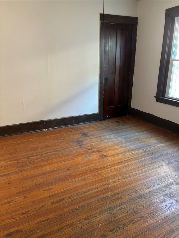 spare room featuring dark hardwood / wood-style flooring