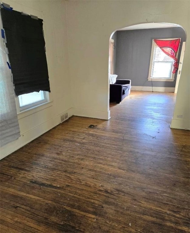 spare room with dark wood-type flooring