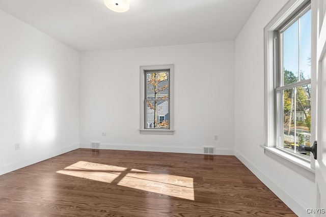 spare room with dark hardwood / wood-style floors