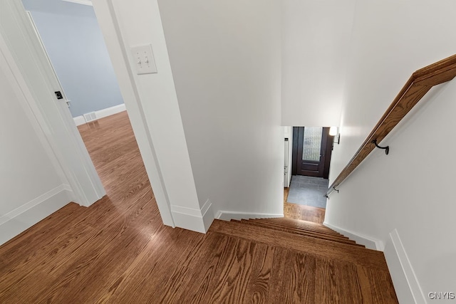 staircase with wood-type flooring