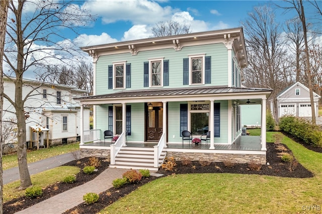 italianate-style house featuring a front yard and a porch