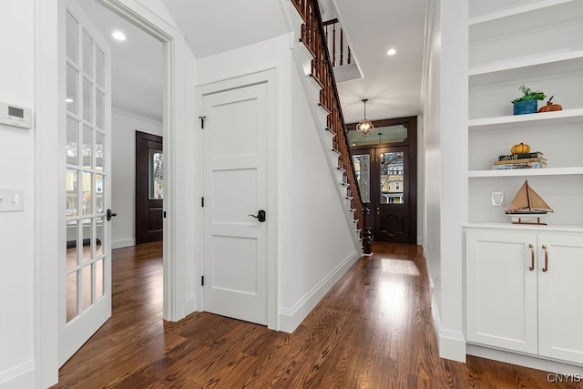 entrance foyer with dark hardwood / wood-style flooring and french doors