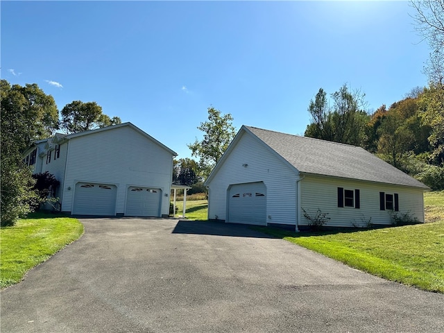 view of home's exterior featuring a yard and a garage