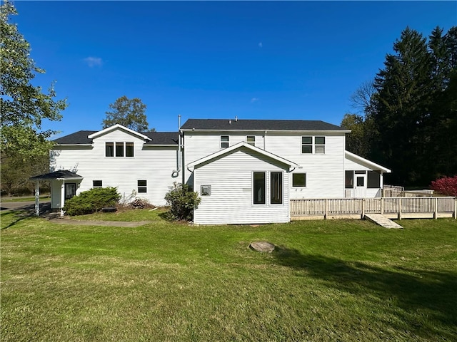 back of house with a lawn