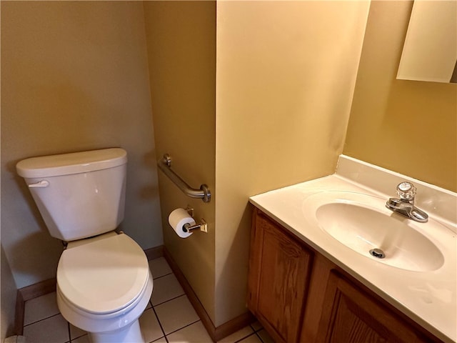 bathroom with vanity, toilet, and tile patterned flooring