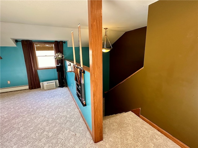 interior space with a baseboard radiator, carpet, lofted ceiling, and a wall unit AC