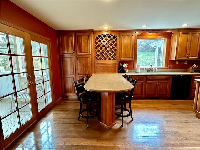 bar with french doors, black dishwasher, sink, and light wood-type flooring