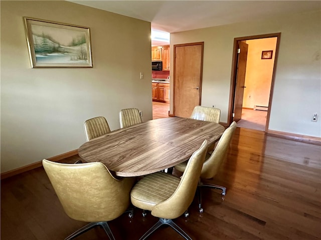 dining room featuring baseboard heating and light wood-type flooring