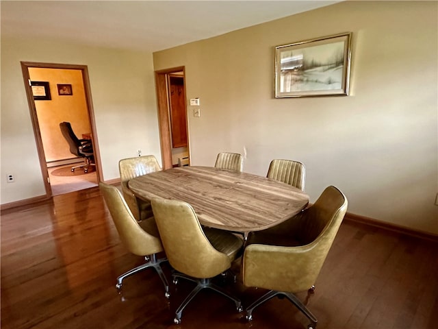 dining area featuring a baseboard radiator and hardwood / wood-style floors