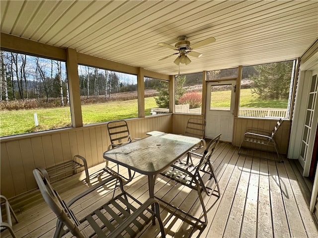 sunroom / solarium with a healthy amount of sunlight and ceiling fan