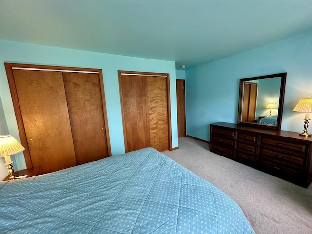 carpeted bedroom with multiple closets