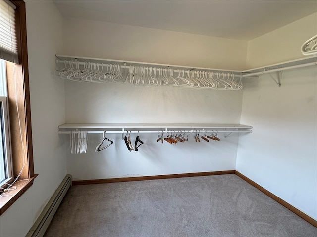 spacious closet featuring carpet and a baseboard radiator