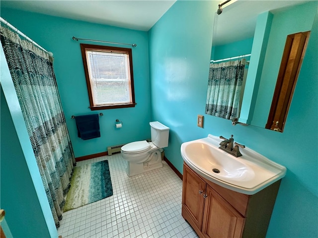 bathroom with toilet, vanity, a baseboard radiator, and tile patterned flooring