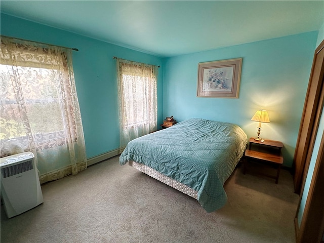 carpeted bedroom with baseboard heating