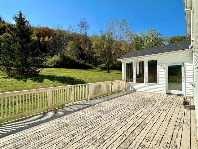 wooden deck featuring a yard