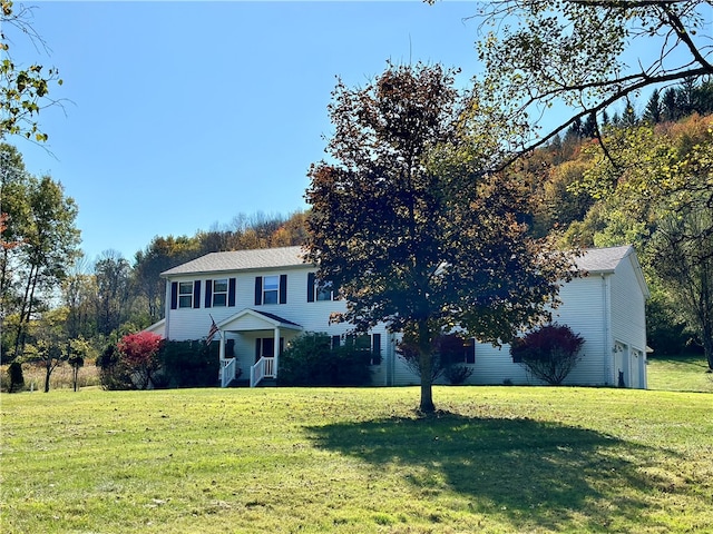 view of front of house with an attached garage and a front yard