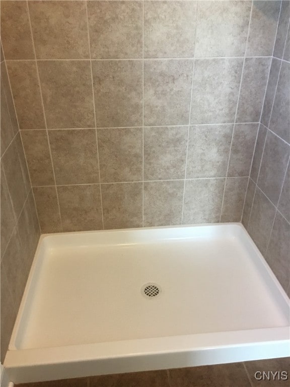 bathroom with a tile shower