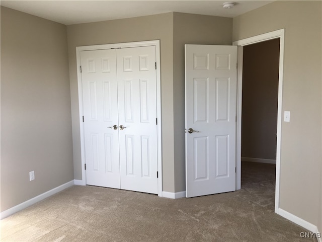 unfurnished bedroom with a closet and carpet