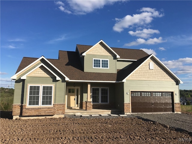 craftsman-style home featuring covered porch and a garage