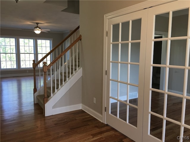 stairway with french doors, hardwood / wood-style flooring, and ceiling fan