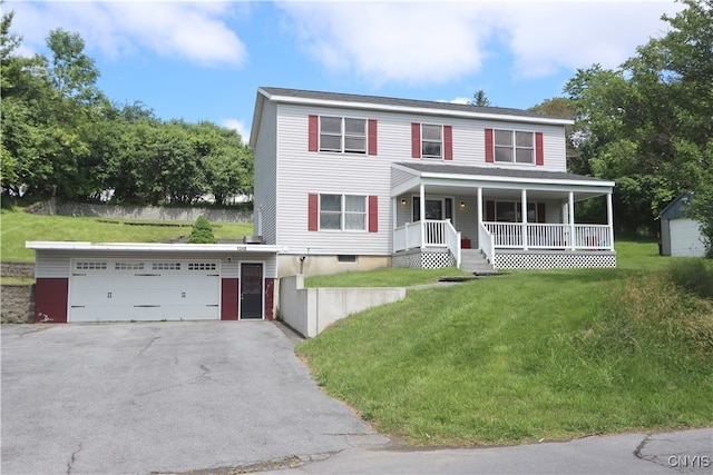 view of front facade featuring a porch, a front yard, and a garage