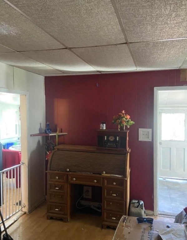 office featuring a drop ceiling and hardwood / wood-style floors