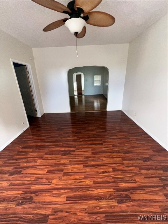 unfurnished room with a textured ceiling, dark hardwood / wood-style flooring, and ceiling fan