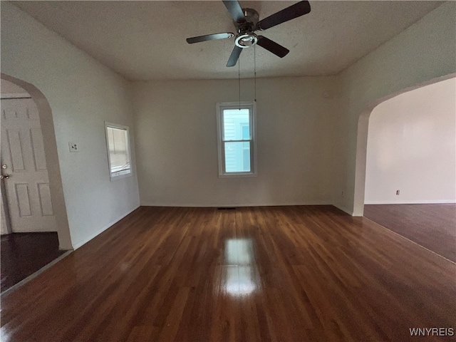 spare room with dark wood-type flooring, ceiling fan, and a textured ceiling