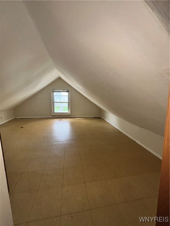 additional living space featuring lofted ceiling