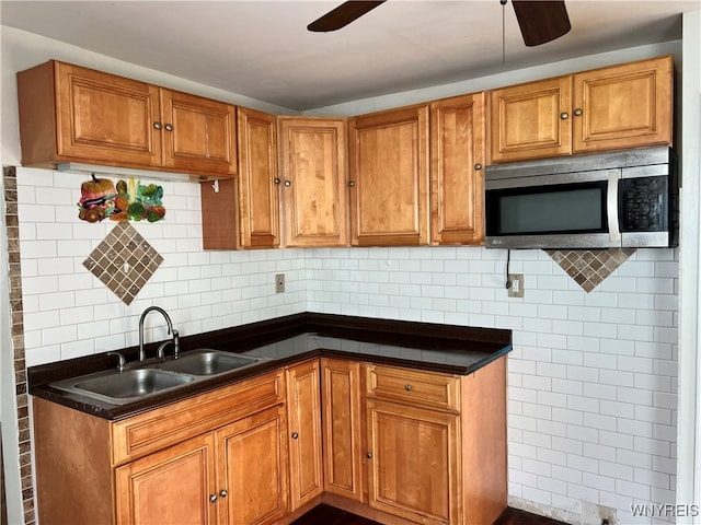 kitchen featuring backsplash, sink, and ceiling fan