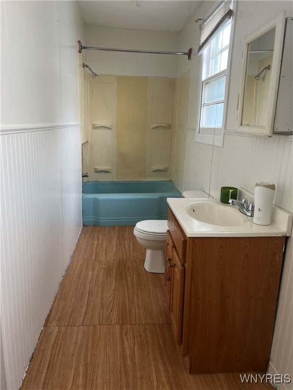 full bathroom featuring wood-type flooring, vanity, toilet, and shower / bathtub combination