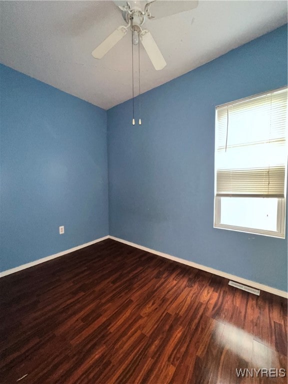 empty room featuring dark hardwood / wood-style floors and ceiling fan