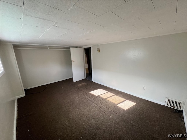 basement with dark colored carpet