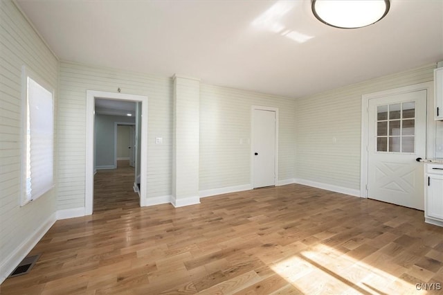 unfurnished room featuring light hardwood / wood-style floors