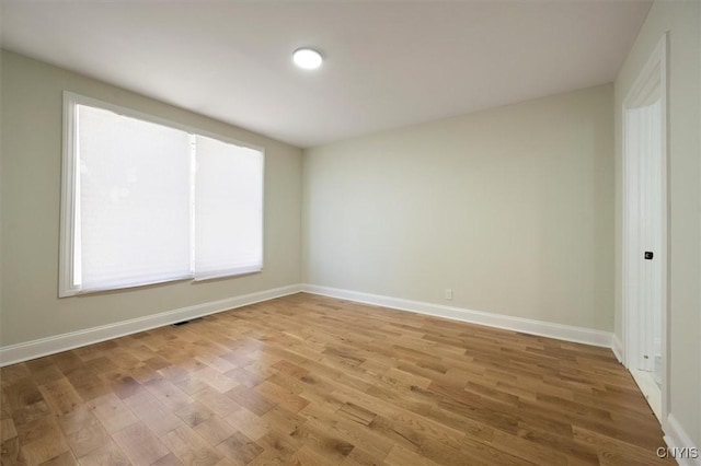 spare room with wood-type flooring