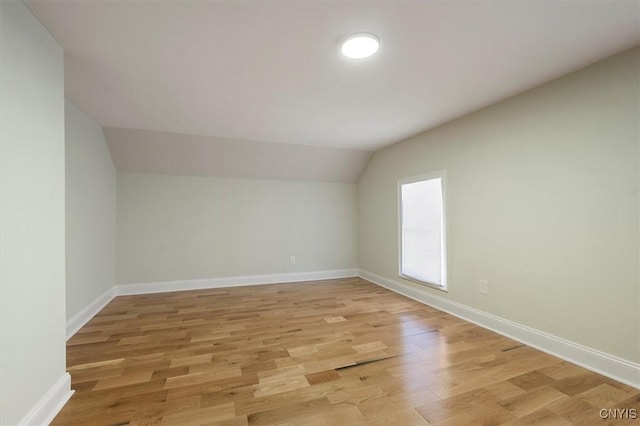 interior space with lofted ceiling and light hardwood / wood-style flooring