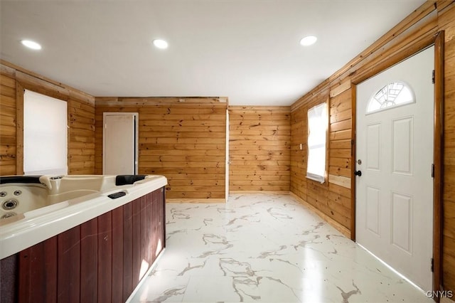 foyer entrance with wood walls and log walls