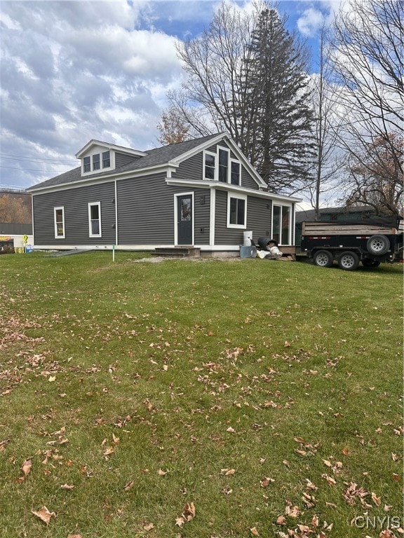 rear view of house with a yard