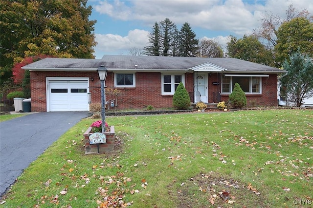 ranch-style home with a front lawn and a garage