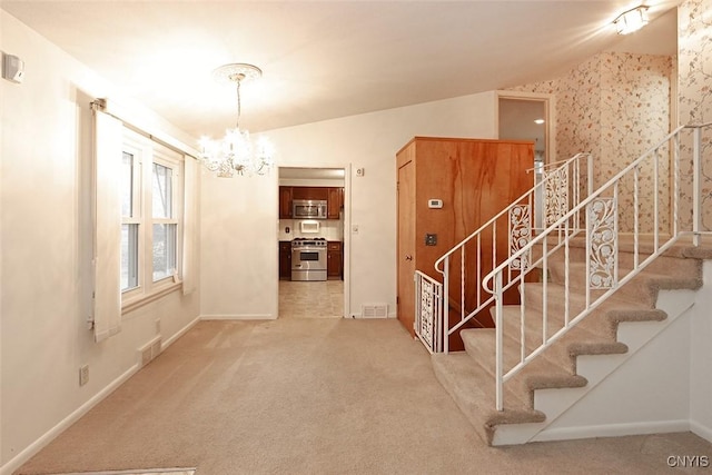 interior space with carpet, an inviting chandelier, and vaulted ceiling