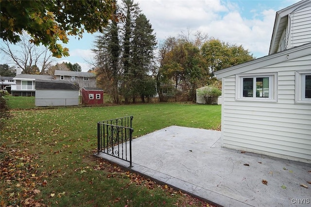 view of yard with a shed and a patio