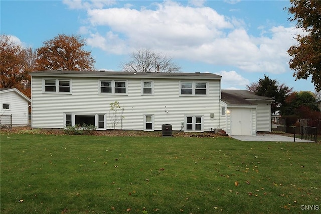 rear view of property with a lawn and central air condition unit